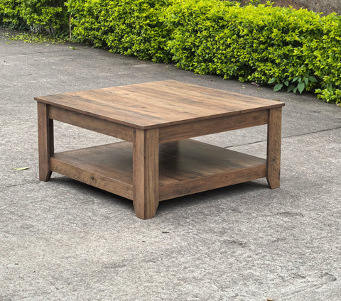 Rustic knotty oak coffee table in a farmhouse-style living room
Side view showing woodgrain texture and lower shelf
Top-down view of the square table surface
Decorated coffee table with books and storage baskets
Compact rustic wood table styled with cozy furniture