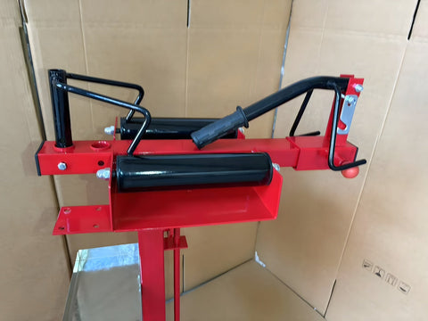 Manual tire changer and spreader stand with red base and swivel platform
Tire changer stand showing adjustable tilt function and tool tray
Manual tire repair stand for light truck tires in auto repair garage
