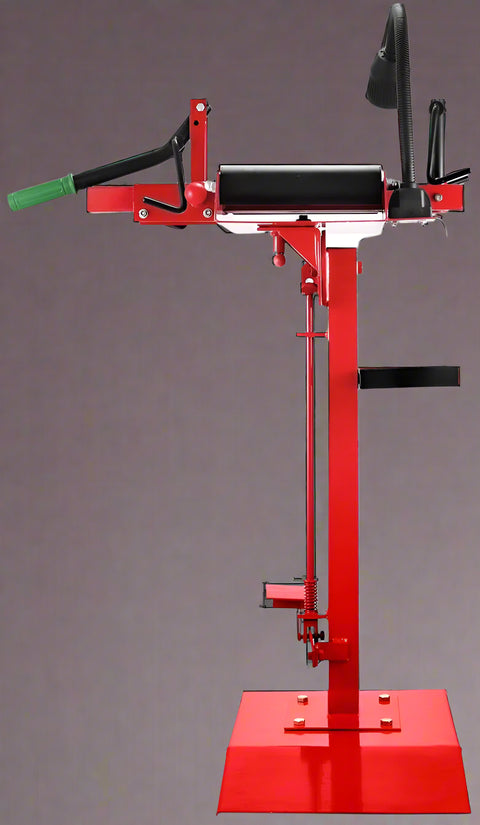 Manual tire changer and spreader stand with red base and swivel platform
Tire changer stand showing adjustable tilt function and tool tray
Manual tire repair stand for light truck tires in auto repair garage