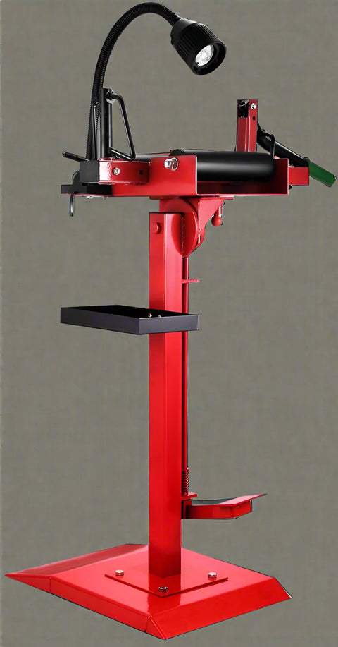 Manual tire changer and spreader stand with red base and swivel platform
Tire changer stand showing adjustable tilt function and tool tray
Manual tire repair stand for light truck tires in auto repair garage