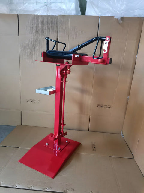 Manual tire changer and spreader stand with red base and swivel platform
Tire changer stand showing adjustable tilt function and tool tray
Manual tire repair stand for light truck tires in auto repair garage