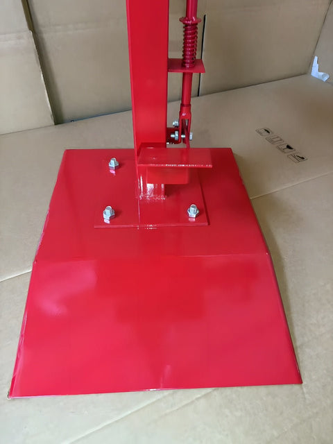 Manual tire changer and spreader stand with red base and swivel platform
Tire changer stand showing adjustable tilt function and tool tray
Manual tire repair stand for light truck tires in auto repair garage