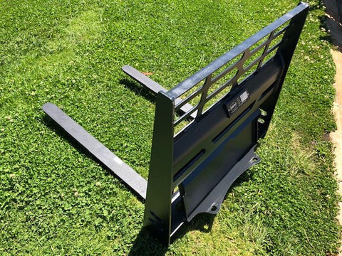 Mini skid steer pallet fork attachment with 2205 lb lift capacity
Heavy-duty pallet forks for Dingo-style mini loaders
Black steel frame and tines for mini skid steer forklift attachment
Compact pallet fork attachment mounted on mini track loader