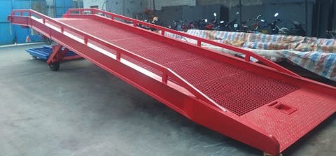 Red 22,000 lb dock ramp showing tread surface and guard rails
