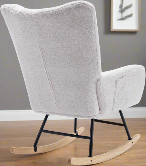 Gray ergonomic glider rocking chair for nursery with wood base
White soft upholstered rocking chair with curved wood base
Rocking chair for the living room with ergonomic support and plush padding