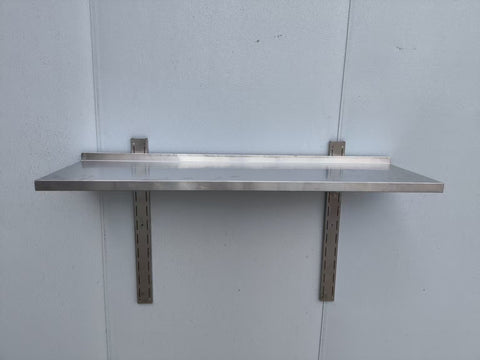 Stainless steel wall-mounted shelf front view
Close-up of shelf bracket and mounting
Side view of stainless steel shelf over prep station
Commercial wall shelf above kitchen counter
Single-tier wall shelf with polished finish