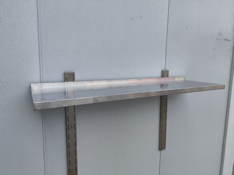 Stainless steel wall-mounted shelf front view
Close-up of shelf bracket and mounting
Side view of stainless steel shelf over prep station
Commercial wall shelf above kitchen counter
Single-tier wall shelf with polished finish