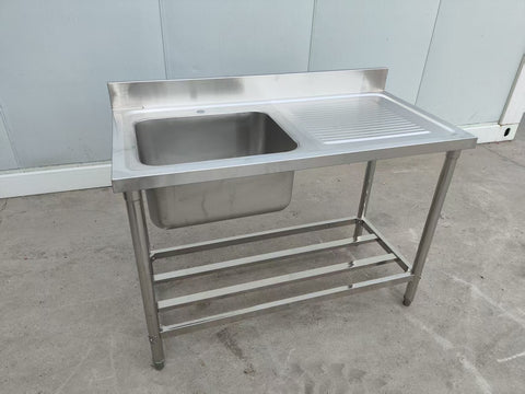 Stainless steel sink with right drainboard and backsplash
Freestanding commercial sink for food prep
Single bowl kitchen sink with undershelf
Heavy-duty stainless sink station front view
Restaurant-grade sink unit with drainboard