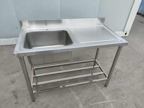 Stainless steel sink with right drainboard and backsplash
Freestanding commercial sink for food prep
Single bowl kitchen sink with undershelf
Heavy-duty stainless sink station front view
Restaurant-grade sink unit with drainboard