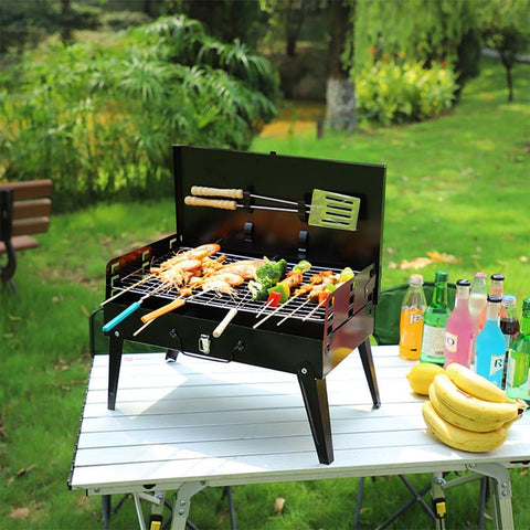 Portable suitcase-style BBQ grill folded open
Compact charcoal grill for travel and camping
Portable BBQ with meat and vegetables on the grill
Folding grill shown in backyard setup
BBQ grill packed for outdoor picnic