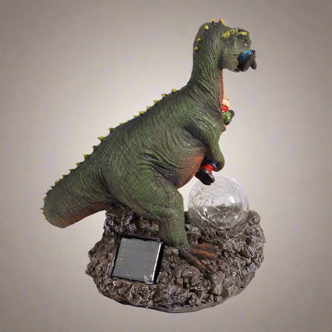 Funny dinosaur garden gnome massacre solar LED light
T-Rex devouring gnomes solar statue for garden decor
Outdoor dinosaur light with solar-powered LED illumination