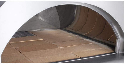 Pizza cooking inside dual-fuel oven outdoors. Full pizza oven on patio with wood and gas tank connected