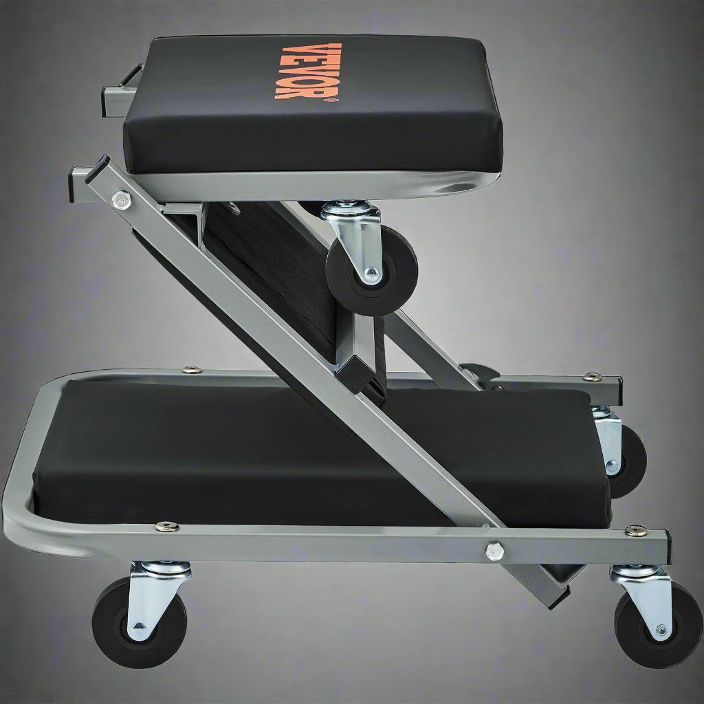 “Folding mechanic creeper seat with wheels and padding”
“2-in-1 creeper and stool in folded position”
“Padded garage creeper stool with Z-frame design”
“Mechanic rolling seat used under car in garage”
“Close-up of caster wheels and vinyl seat cushion”