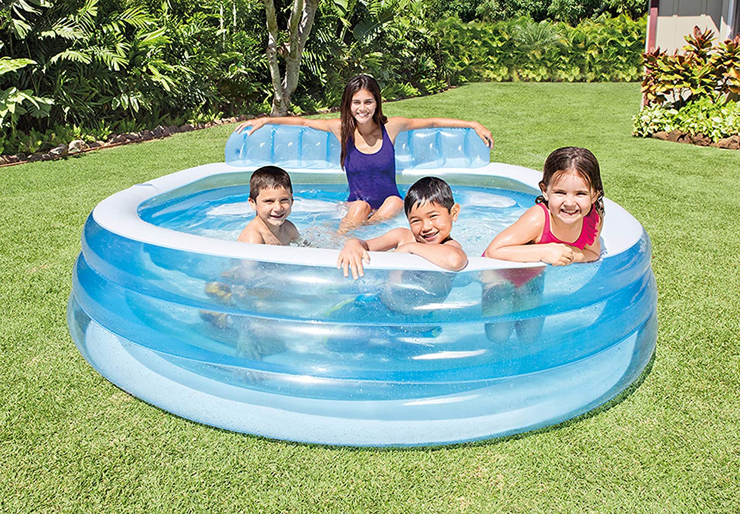 Intex Swim Center Family Lounge Pool with kids

Top view of inflatable lounge pool with bench

Inflatable family pool with built-in seat and backrest

Parents and kids relaxing in backyard pool

Blue vinyl family-size lounge pool filled with water