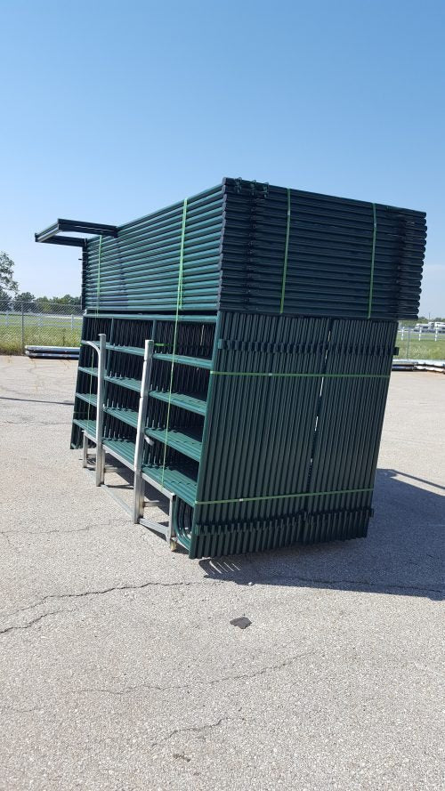 Side angle of stacked livestock fence panels on ranch storage yard