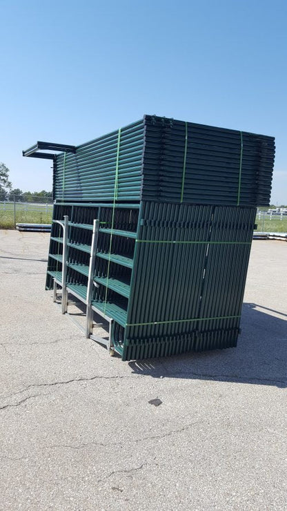 Side angle of stacked livestock fence panels on ranch storage yard
