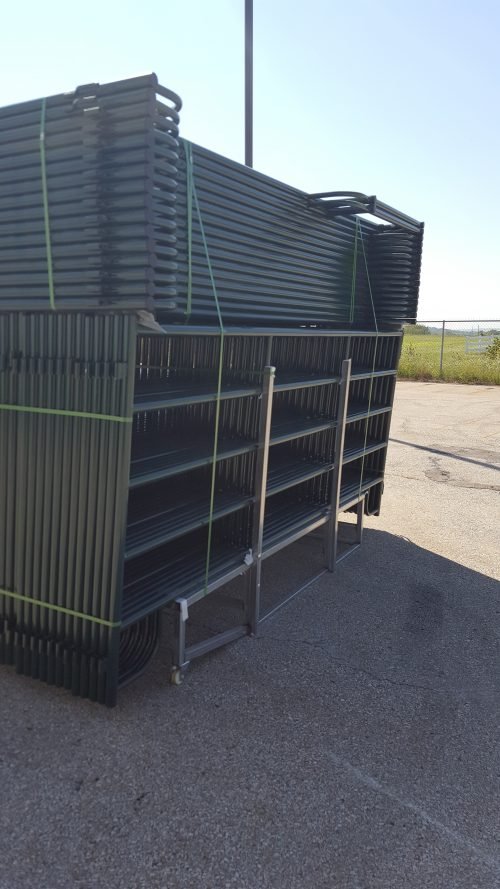 Green ranch fence panels aligned for distribution – side profile