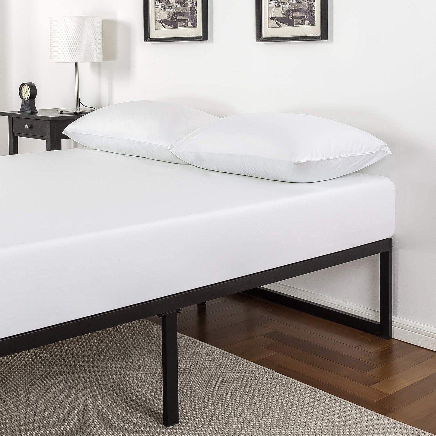 Queen size metal bed frame with mattress in minimalist white bedroom