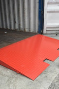 Forklift approaching steel loading ramp for container access