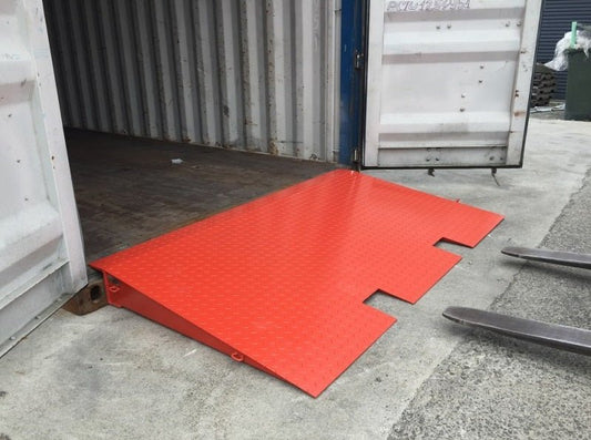 Forklift approaching steel loading ramp for container access