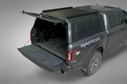 Side view of heavy-duty steel truck topper on black pickup
Modular canopy with open gullwing side door
Lockable utility cap rear view
Installation components of modular truck canopy
Steel topper installed on full-size pickup truck