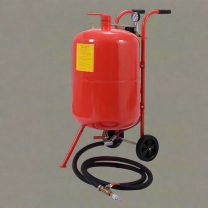 Red 20-gallon portable sandblasting tank with hose, wheels, and blasting accessories for rust and paint removal
