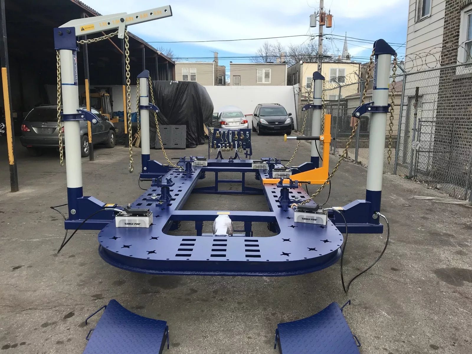 22 ft 4-tower hydraulic frame puller machine for professional collision repair. Heavy-duty frame puller with steel platform and anchoring clamps.  10-ton hydraulic tower on autobody frame straightening system