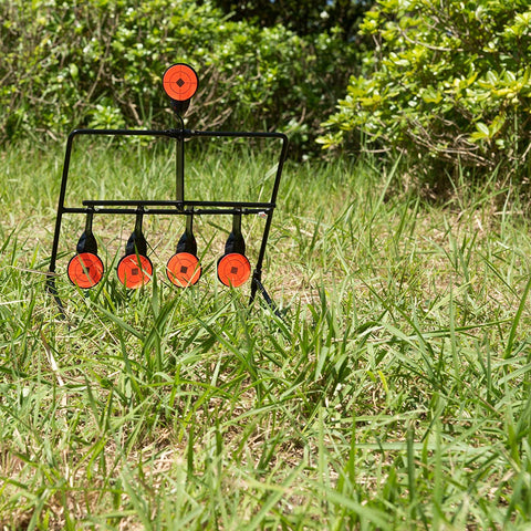 .22 resetting steel shooting target with six orange spinner paddles in grassy field
