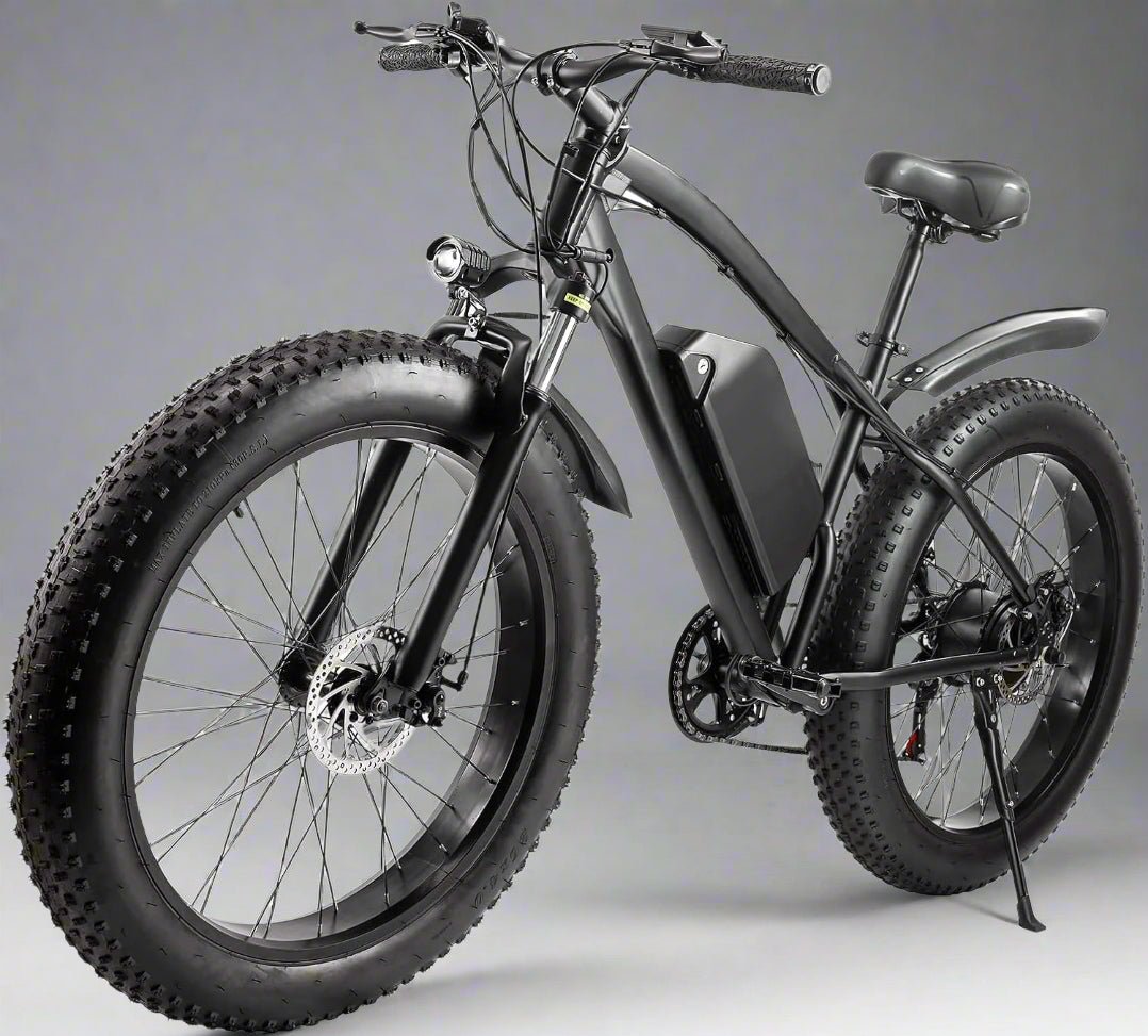 Matte black electric fat tire mountain bike side profile

Rider using e-bike on snowy terrain

Close-up of 350W rear hub motor

Heavy-duty disc brakes on fat tire

Fat tire grip on sand and off-road trails
