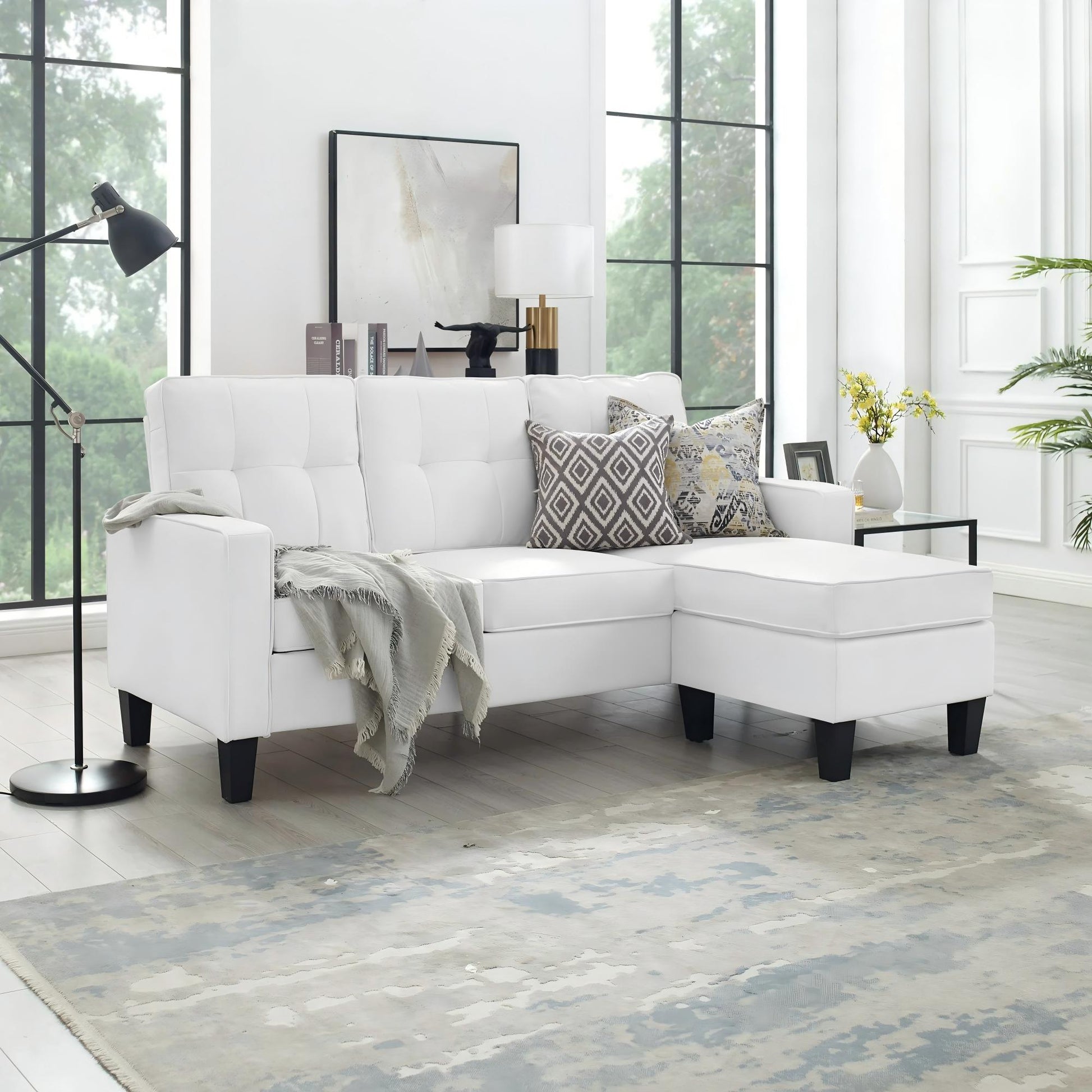 Reversible black sectional sofa in small apartment

Brown 3-seater L-shaped couch in modern room

White PU leather couch with chaise on right

Compact living room with small space sectional