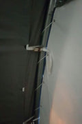 Roll-up front door of large industrial fabric shelter with white PVC cover