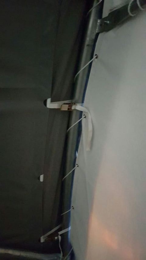 Roll-up front door of large industrial fabric shelter with white PVC cover