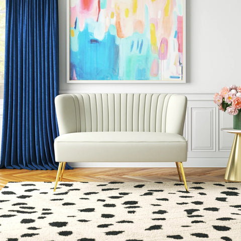 Fuchsia velvet loveseat with tufted back and gold legs in modern decor.
Ivory armless loveseat sofa with mid-century design in studio setup.
Tan velvet 2-seater with flared gold legs styled against a neutral wall.
Close-up of plush velvet texture and fluted backrest detail.
Color swatches displaying Fuchsia, Pink, Ivory, and Tan options.