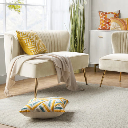 Fuchsia velvet loveseat with tufted back and gold legs in modern decor.
Ivory armless loveseat sofa with mid-century design in studio setup.
Tan velvet 2-seater with flared gold legs styled against a neutral wall.
Close-up of plush velvet texture and fluted backrest detail.
Color swatches displaying Fuchsia, Pink, Ivory, and Tan options.