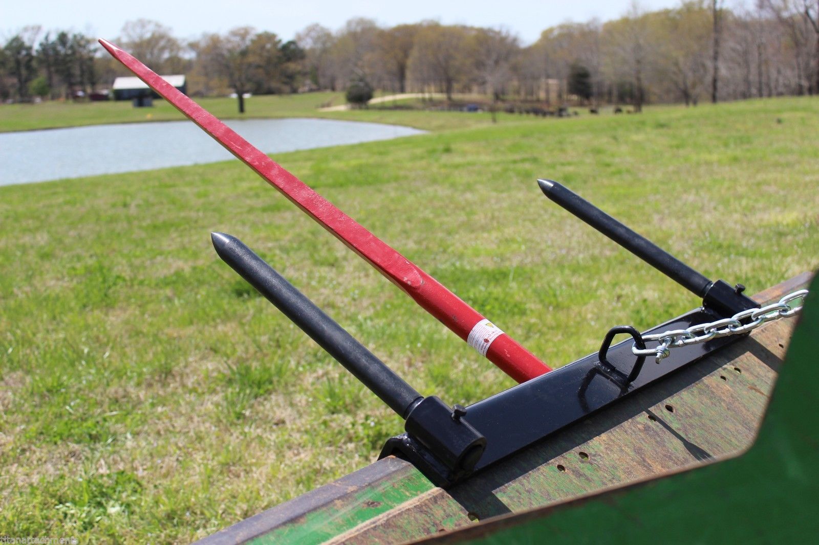 Triple Hay Bale Spears Attachment – Mounted on Loader

49-Inch Spear Fork Attachment – Top View

Bucket Attachment for Hay Bales – Side View

HY49 Red Steel Frame with Spears – Ground Placement

Close-up of Chains and Turnbuckle on Bucket Attachment

