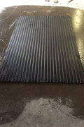 interlocking rubber flooring stacked in garage setting