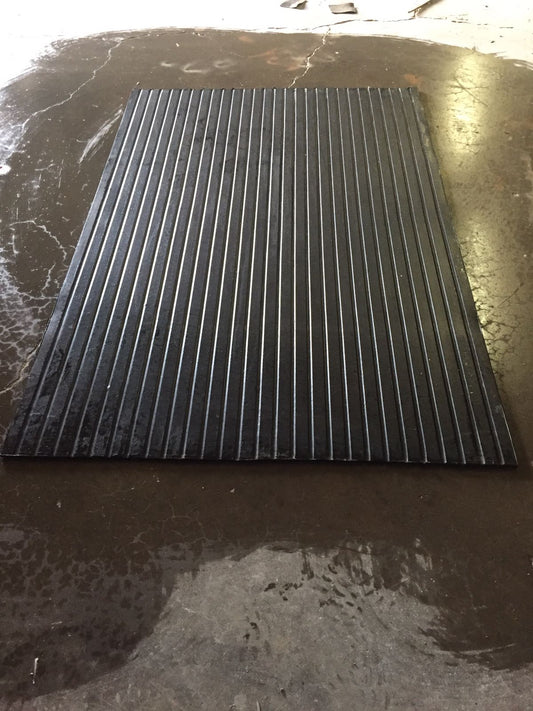 interlocking rubber flooring stacked in garage setting