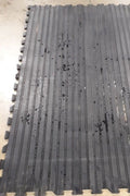 textured rubber stall mat close-up for horse barn