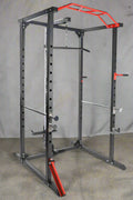 Heavy-duty gym power rack with LAT pulldown and weight plate storage
Squat cage with adjustable J-hooks and multi-grip pull-up bar
LAT pulldown attachment and cable system on power rack
Full side view of squat rack setup for home gym use
Rear view of power cage showing plate storage and cable attachment