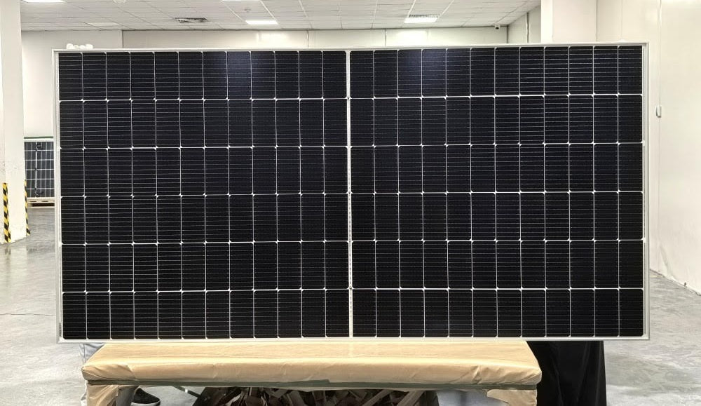 "565W bifacial monocrystalline solar panel front view"
"144-cell high-efficiency solar module close-up"
"Solar panel showing rear energy capture and wiring"
"Commercial-grade bifacial solar panel in warehouse"