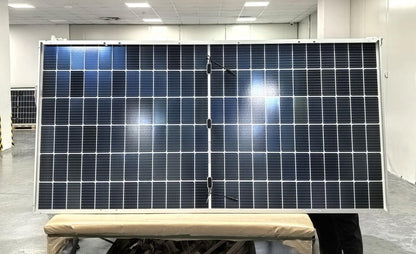 "565W bifacial monocrystalline solar panel front view"
"144-cell high-efficiency solar module close-up"
"Solar panel showing rear energy capture and wiring"
"Commercial-grade bifacial solar panel in warehouse"