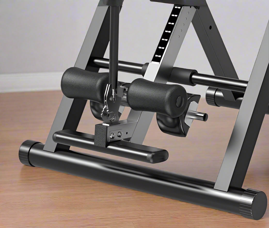 Folding inversion table for back pain relief and spinal decompression
Adjustable inversion table for home use and fitness therapy
Close-up of padded backrest and ankle support on inversion table
Foldable back stretcher in upright storage position
User on inversion table demonstrating full inversion angle