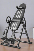 Folding inversion table for back pain relief and spinal decompression
Adjustable inversion table for home use and fitness therapy
Close-up of padded backrest and ankle support on inversion table
Foldable back stretcher in upright storage position
User on inversion table demonstrating full inversion angle