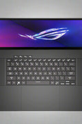ASUS ROG Zephyrus G16 Laptop with RGB keyboard and OLED screen
Side profile of Zephyrus G16 showcasing slim build
Rear ventilation and ASUS ROG logo on lid