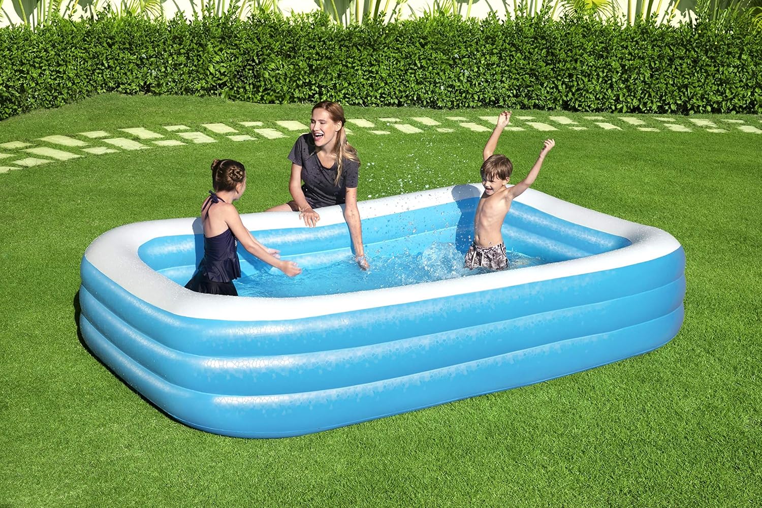 Bestway inflatable rectangular paddling pool with family inside

Top-down view of Bestway blue inflatable pool

Inflatable pool on grass with children playing

Side angle of Bestway pool showing two air chambers

Dimensions of Bestway family pool

Family enjoying inflatable pool in the backyard

Rectangular Bestway paddling pool setup outdoors