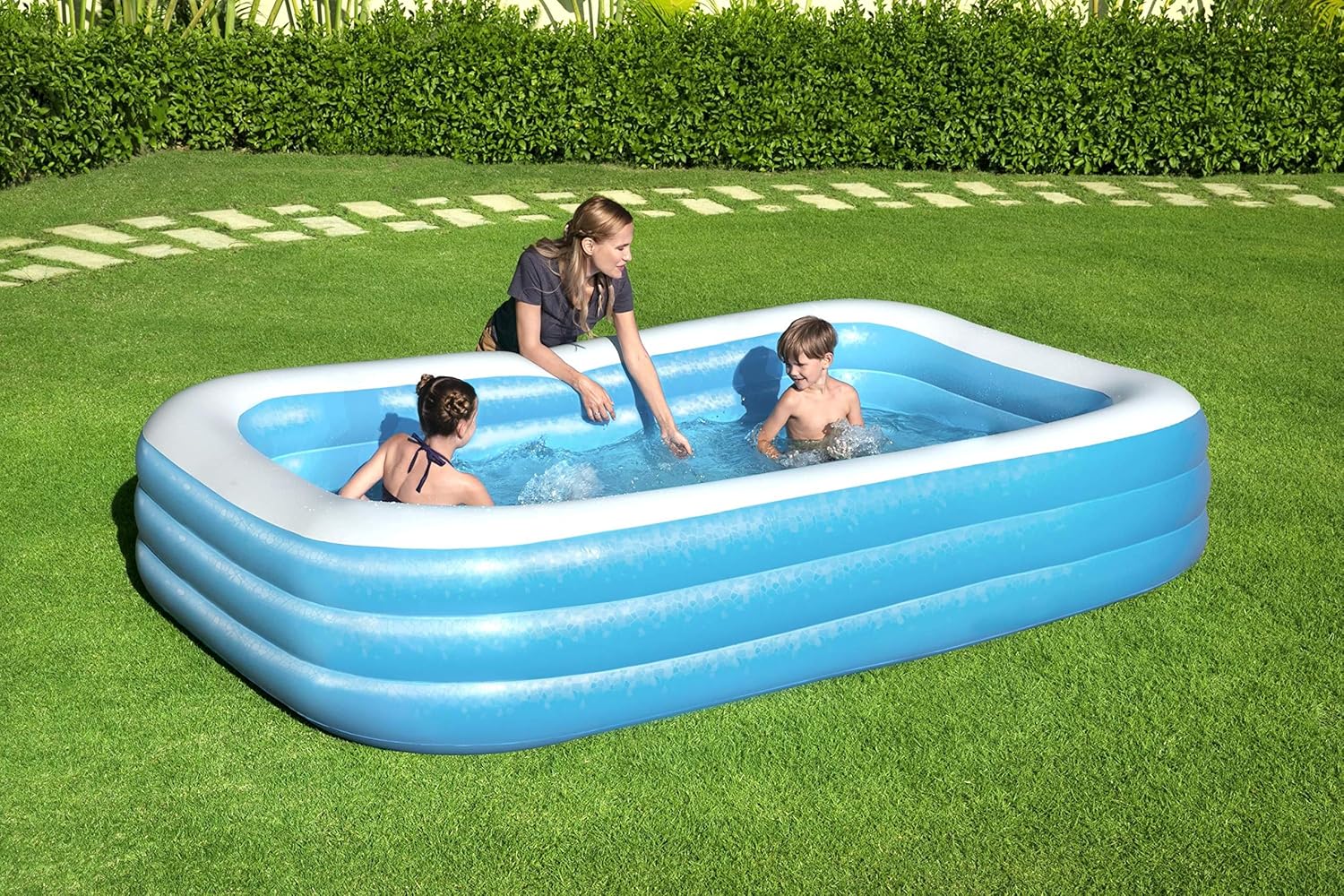Bestway inflatable rectangular paddling pool with family inside

Top-down view of Bestway blue inflatable pool

Inflatable pool on grass with children playing

Side angle of Bestway pool showing two air chambers

Dimensions of Bestway family pool

Family enjoying inflatable pool in the backyard

Rectangular Bestway paddling pool setup outdoors