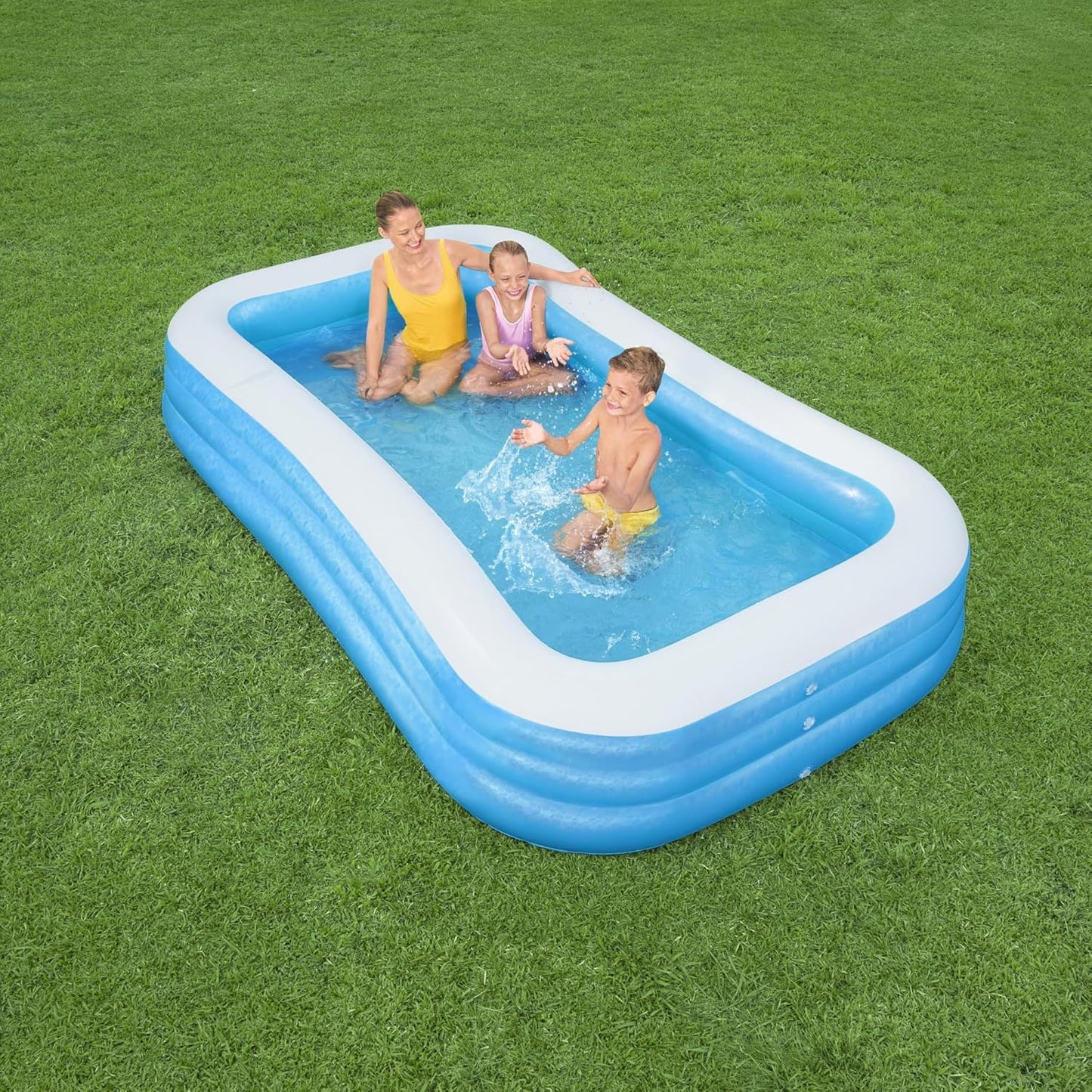 Bestway inflatable rectangular paddling pool with family inside

Top-down view of Bestway blue inflatable pool

Inflatable pool on grass with children playing

Side angle of Bestway pool showing two air chambers

Dimensions of Bestway family pool

Family enjoying inflatable pool in the backyard

Rectangular Bestway paddling pool setup outdoors
