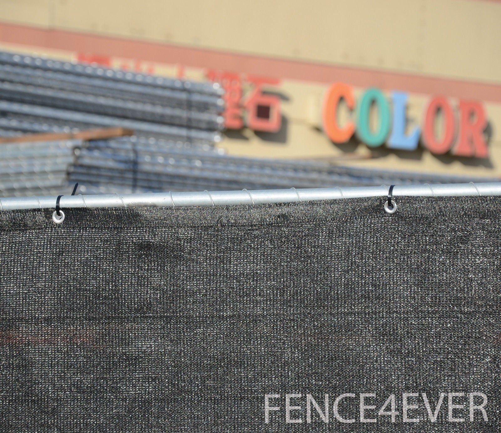 Black construction site fence screen providing wind and dust barrier