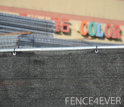 Black construction site fence screen providing wind and dust barrier