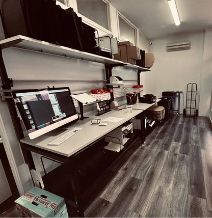 Full view of heavy-duty 61” packing workstation with shelves and pegboard

Side view of workbench with keyboard tray and dispenser

Close-up of adjustable table height and MDF tabletop

Pegboard and shelf configuration in use

Dispenser bar and printer shelf setup